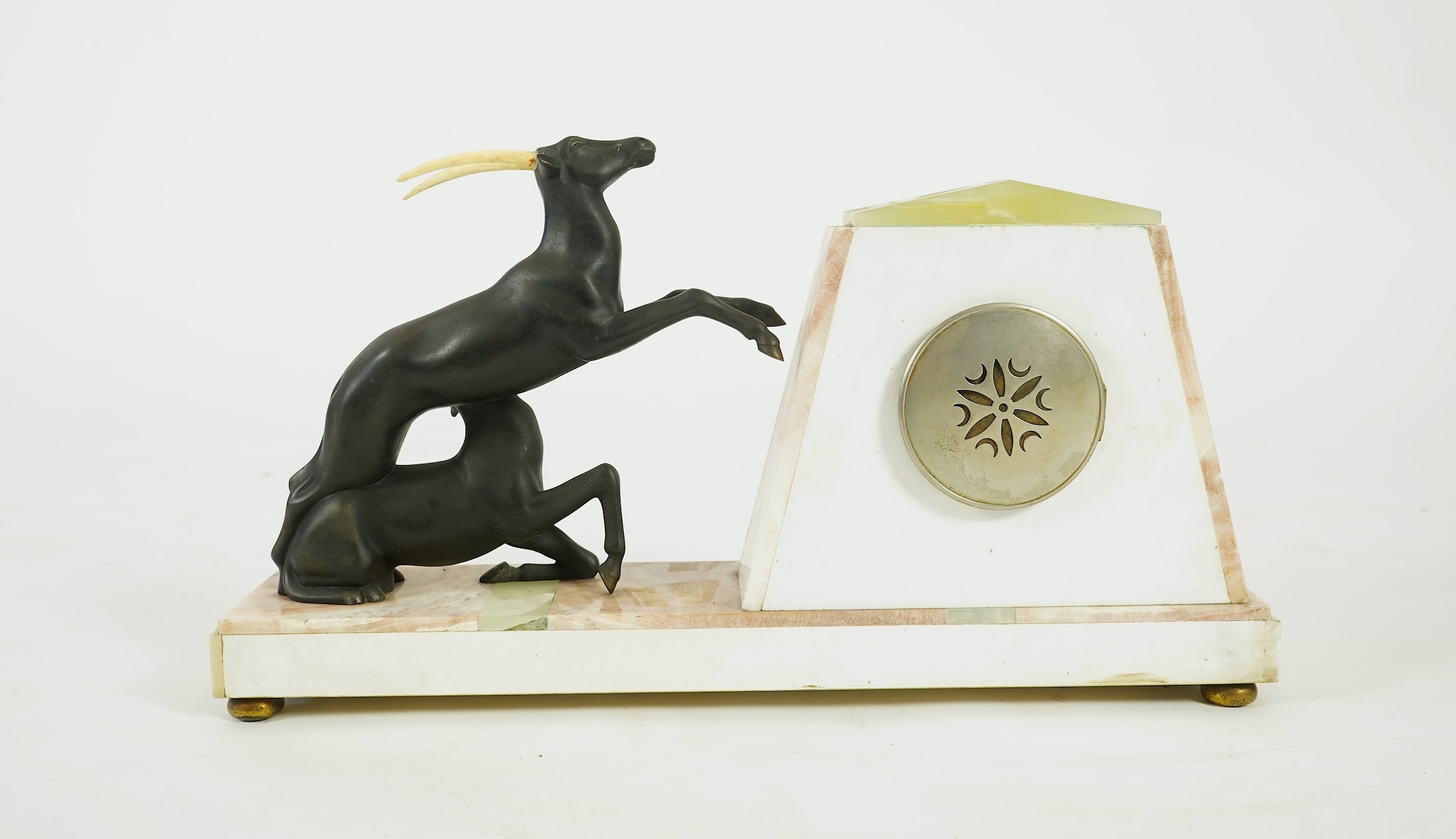 Attributed to Uriano (Ugo Cipriani, Italian, 1897-1960), a French green and cream onyx pyramid shaped clock